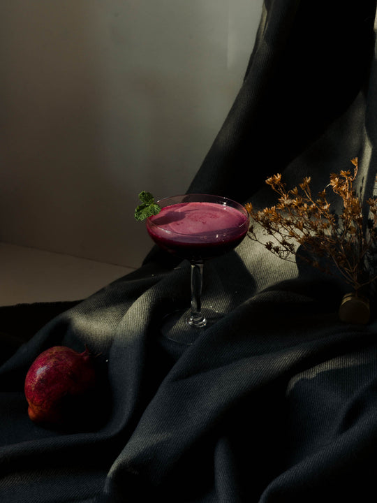 Pomegranate Beetroot Fizz sitting in light with shadow play 