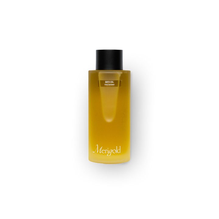 Merigold Bath Oil in frosted clear glass bottle with black cap – nourishing, moisturizing body treatment for dry or sensitive skin, used for self-care and ritual bathing.