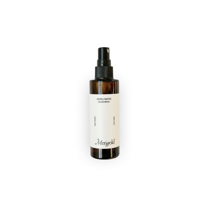 Merigold Neroli Water — a refreshing, natural facial mist made with pure neroli hydrosol to tone, balance, and uplift the skin and senses. Packaged in an amber glass bottle with minimalist white label and black spray top.