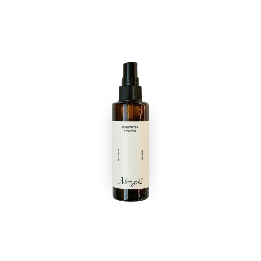 Merigold Rose Water — a clean, gentle facial mist made with pure rose hydrosol to hydrate, soothe, and refresh skin. Packaged in an amber glass bottle with minimalist white label and black spray top.