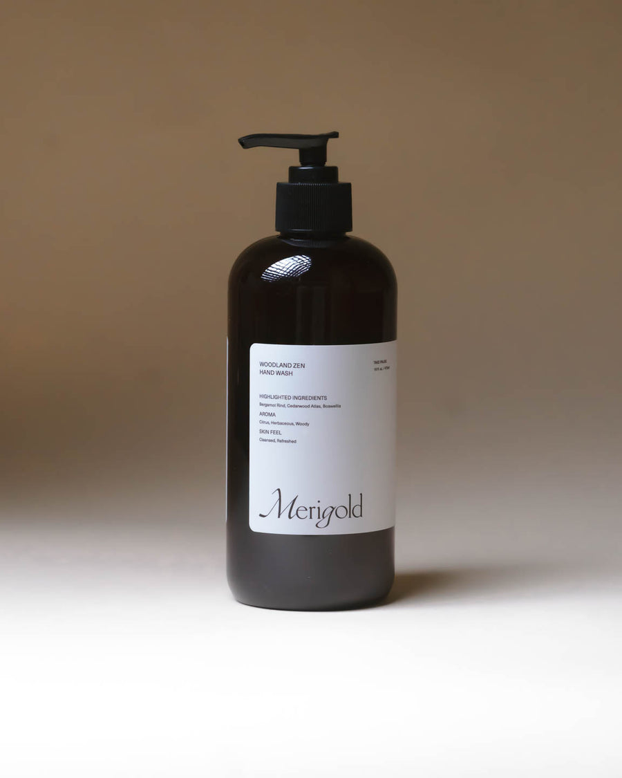 Merigold Woodland Zen Hand Soap in 15 fl oz amber pump bottle on minimal backdrop, natural aromatic hand wash.