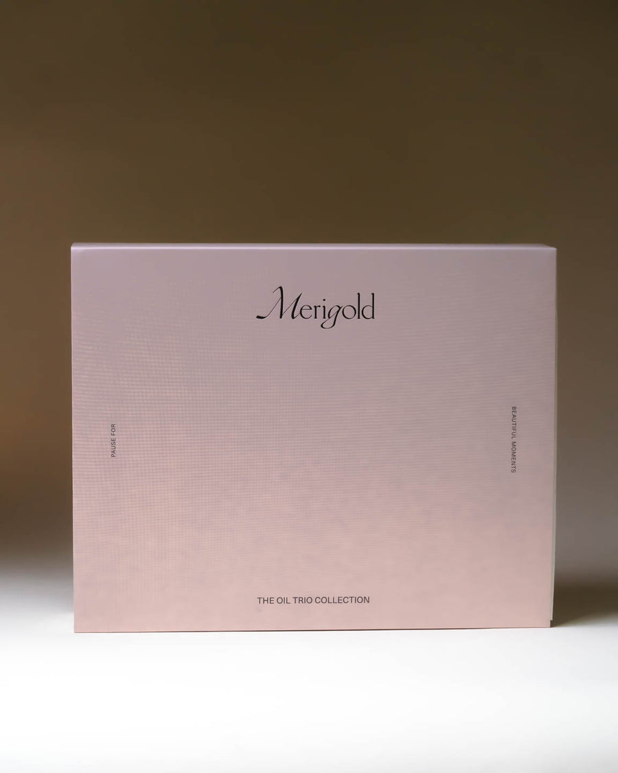Merigold Full-Size Oil Trio Collection in blush pink box featuring Revive and Restore Cleansing Oil, Hydrate and Glow Facial Oil, and Night Nourisher Serum.