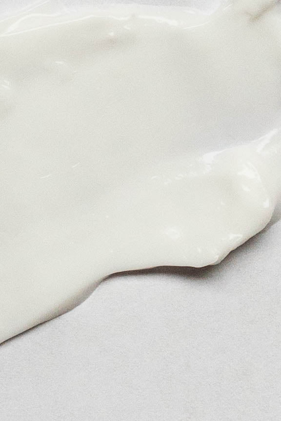 Merigold Lavender Eucalyptus Hand Cream close-up of the velvety white creamy hand cream on a minimal neutral background.