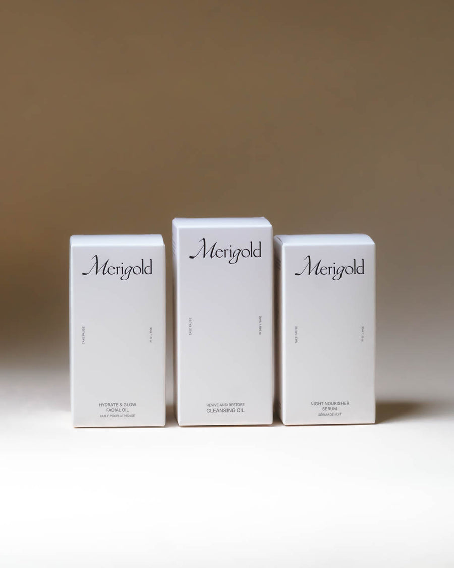 Merigold Oil Trio packaging shown in three white boxes for Revive and Restore Cleansing Oil, Hydrate and Glow Facial Oil, and Night Nourisher Serum.