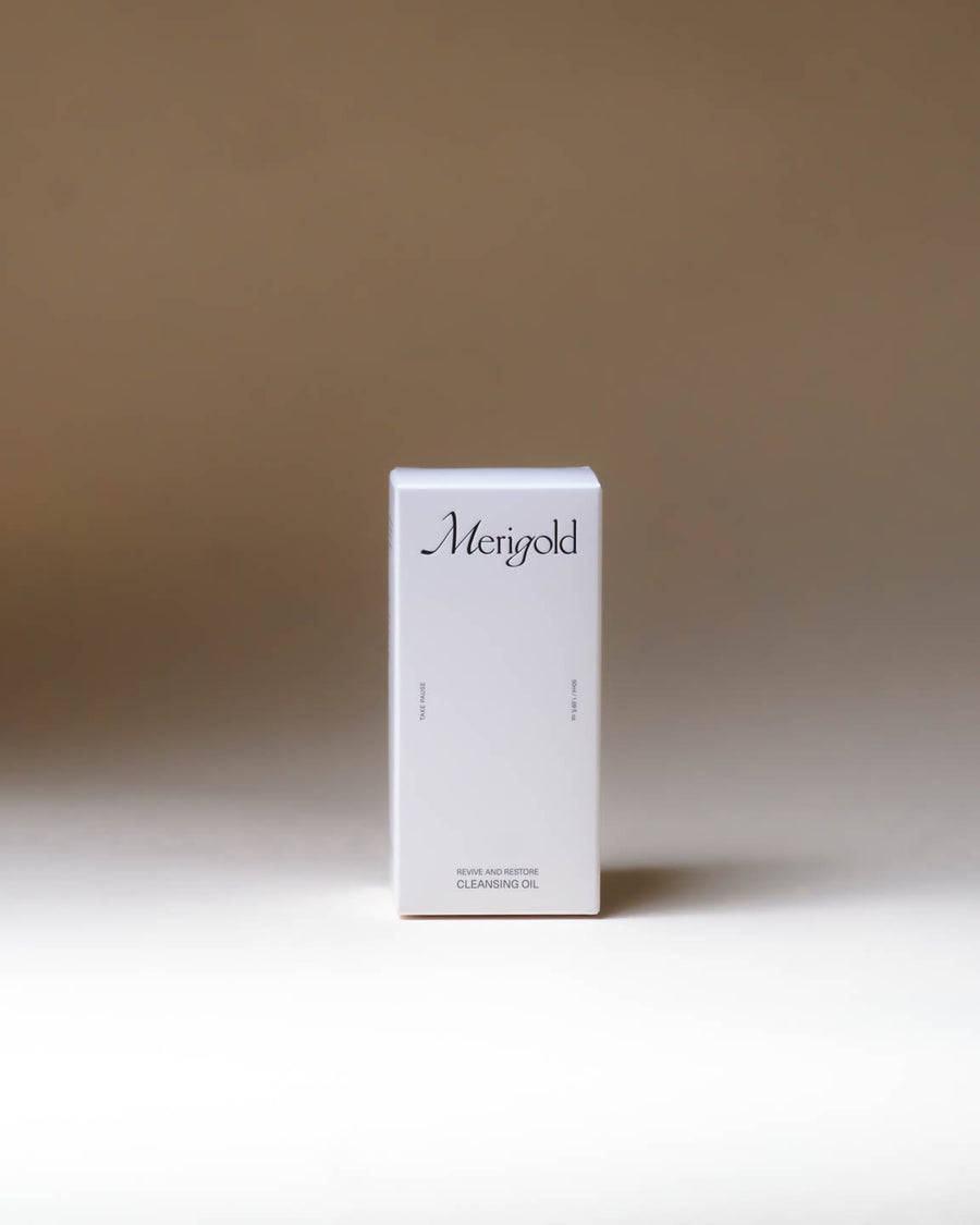 Merigold Revive and Restore Cleansing Oil white box packaging, minimal clean skincare branding for natural oil cleanser.