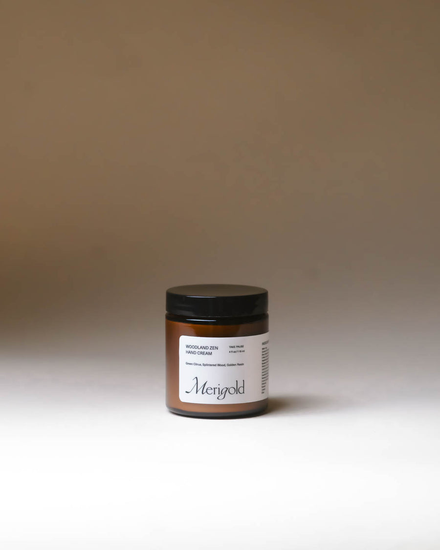 Merigold Woodland Zen Hand Cream in a glass amber jar, grounding botanical moisturizer. Minimal background. 