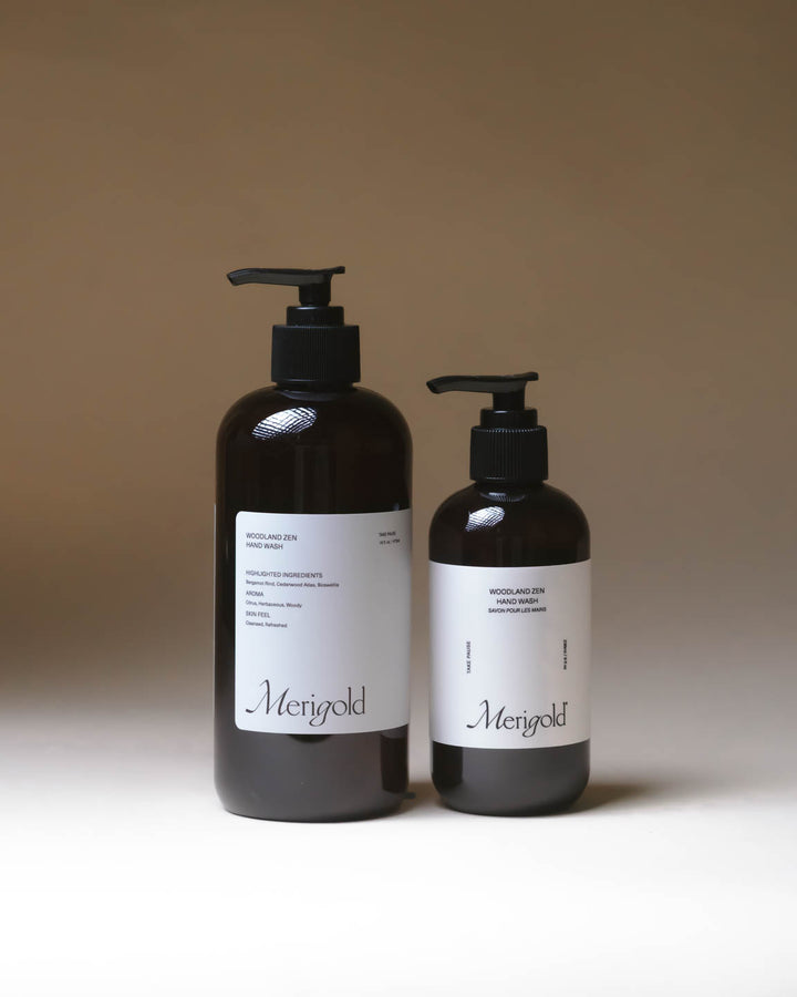 Merigold Woodland Zen Hand Soap in two amber pump bottle sizes, grounding botanical hand wash for gentle daily cleansing.